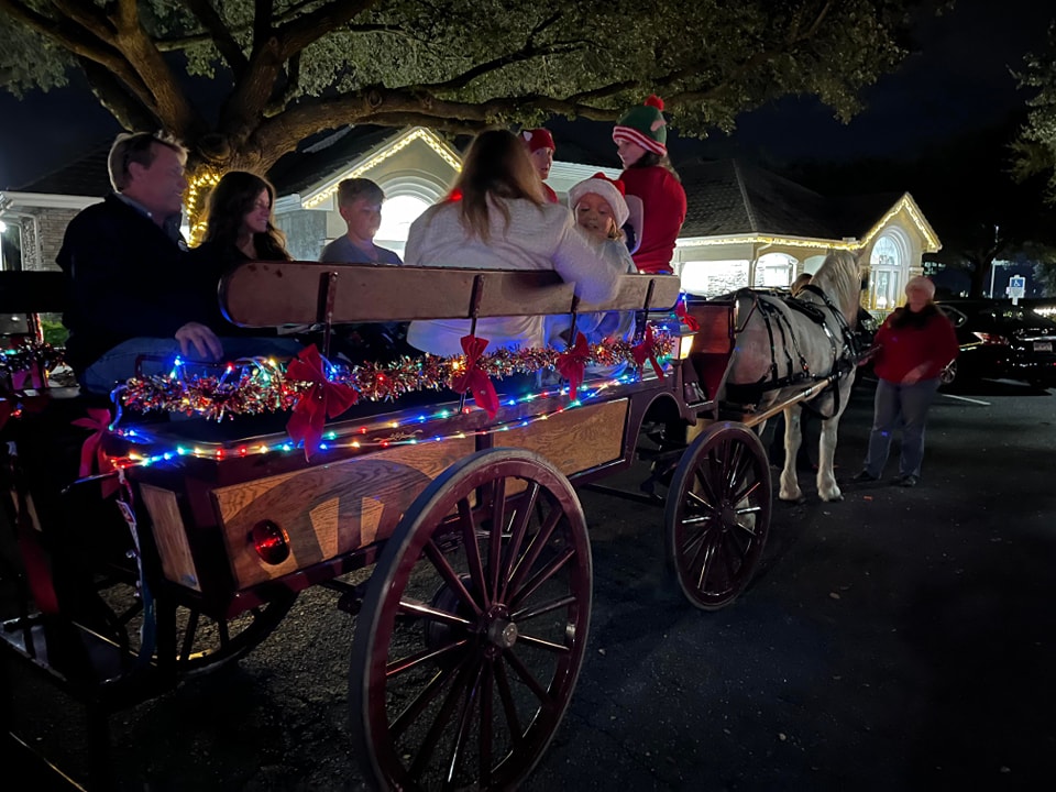 Here's our Big Red Wagon giving a lighted holiday carriage ride with caroling in Jacksonville, Florida.